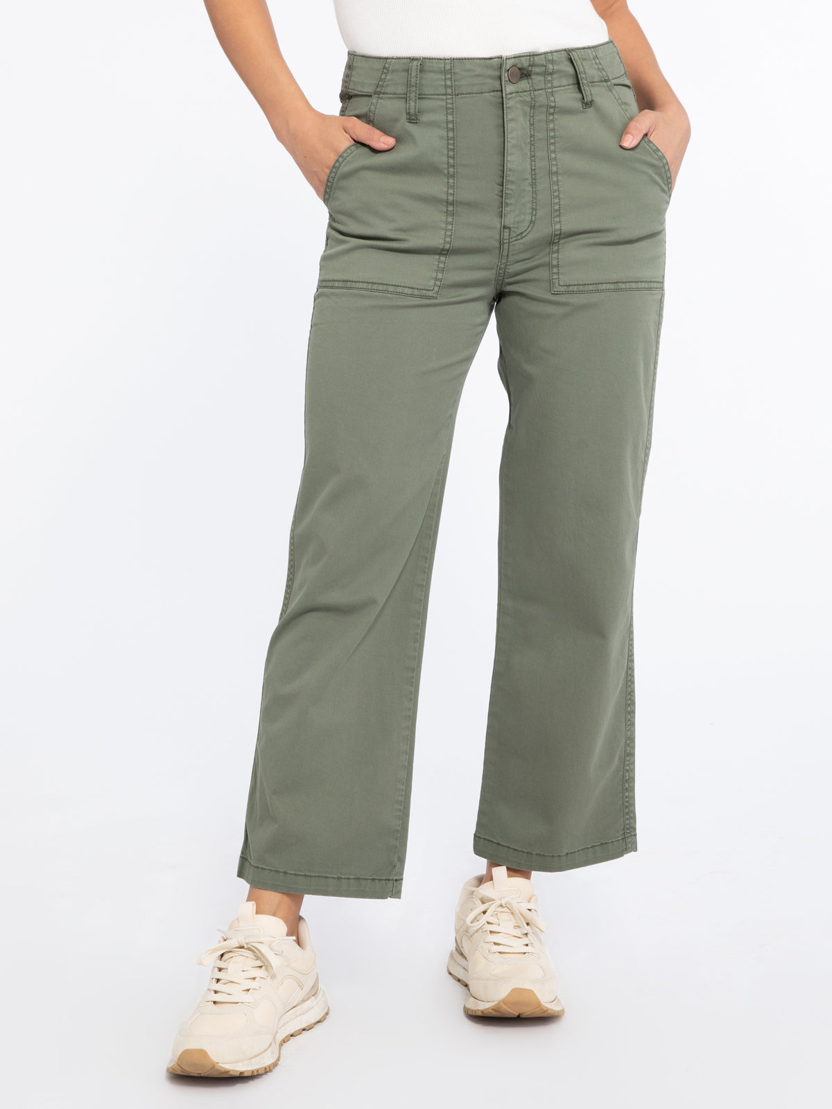 Model wearing green Vacation Crop Hiker Green pants from Sanctuary with white tank top and cream running shoes (7351187734736)