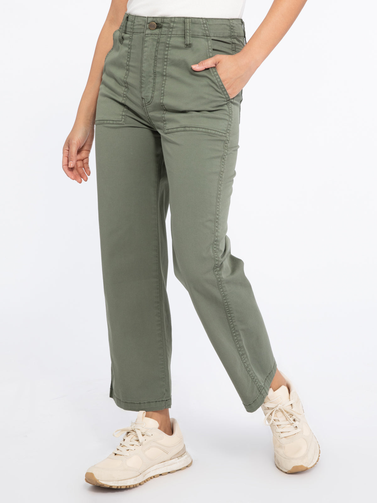 Model wearing green Vacation Crop Hiker Green pants from Sanctuary with white tank top and cream running shoes (7351187734736)