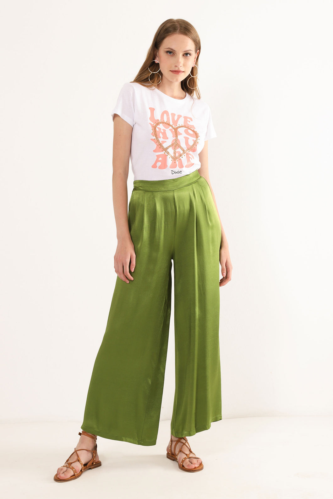 Model wearing Amazonia Wide leg pants from Dixie with white T-shirt and brown sandals. (7720836169936)