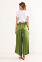 Load image into Gallery viewer, Model wearing Amazonia Wide leg pants from Dixie with white T-shirt and brown sandals. (7720836169936)
