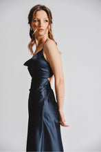 Load image into Gallery viewer, Woman is wearing Molly Bracken strappy cowl neck slip dress. Dress features cowl neck, adjustable straps and crisscross tie back. the dress is navy blue.. (7724325011664)

