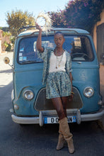 Load image into Gallery viewer, The model is wearing Molly Bracken High waisted shorts and shirts with leaf-like blue prints with white knitted tanktop and beige high heel boots (7724308365520)
