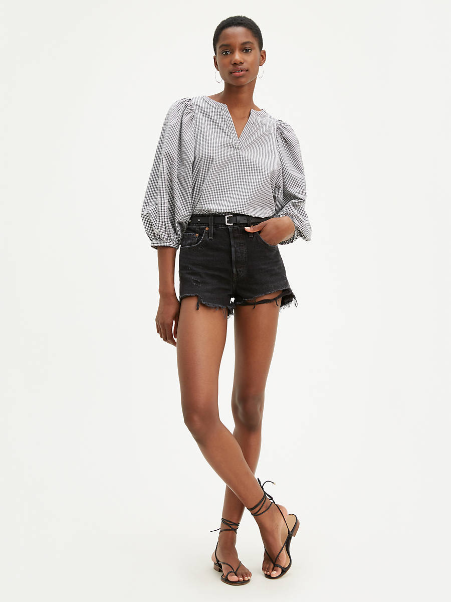 Woman is wearing Levi's 501 original high waist shorts. Black Denim shorts feature a vintage inspired fit, chewed hem high waist. Denim shorts paired with striped long sleeve blouse and black sandals (7721839100112)