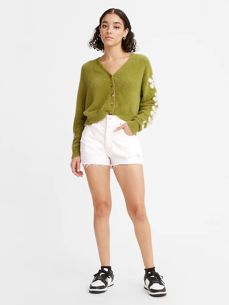 Women is wearing Levi's 501 Original High Waist shorts. Jean shorts are white color and feature high waist, loose fit and chewed hem. Jean shorts are paired with green sweater. (7721826975952)