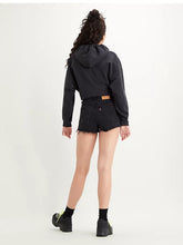 Load image into Gallery viewer, Woman is wearing Levi&#39;s ribcage shorts. The jean shorts are featuring high waist and slightly loose fit. Shorts are paired with black Levi&#39;s hoodie and black sneakers.  The photo demonstrates the shorts from the back. (7721827795152)

