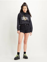 Load image into Gallery viewer, Woman is wearing Levi&#39;s ribcage shorts. The jean shorts are featuring high waist and slightly loose fit. Shorts are paired with black Levi&#39;s hoodie and black sneakers.   (7721827795152)
