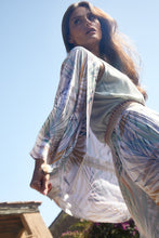 Load image into Gallery viewer,  Woman is wearing puffs long sleeves with pointed collar shirt from Molly Bracken, with allover beige, green, golden beech palm prints on white. She is wearing it with green top and same printed pants. (7724299944144)
