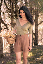 Load image into Gallery viewer, Model wearing sage Lara Top with brown shorts. (7702610444496)
