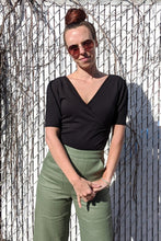 Load image into Gallery viewer, Model wearing black Lara Top with green pants.. (7702610444496)
