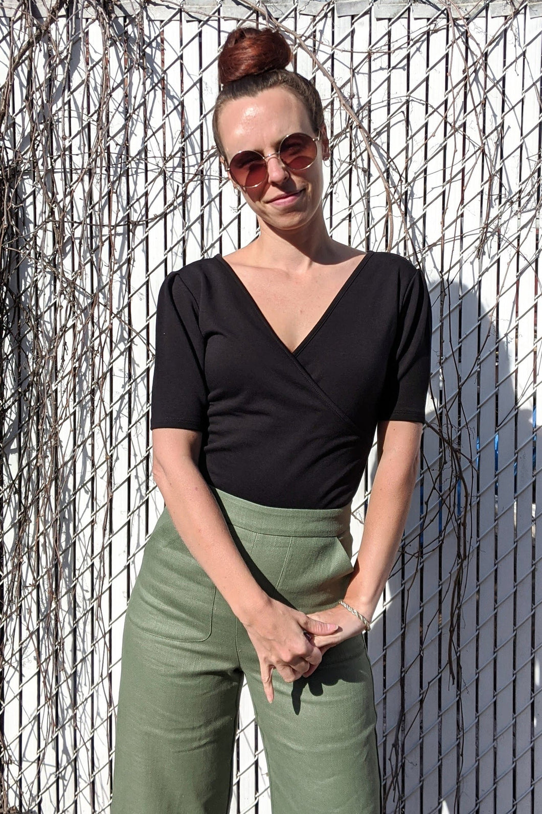 Model wearing black Lara Top with green pants.. (7702610444496)