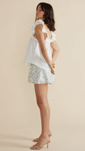 Load image into Gallery viewer, Model wearing white Leigh Top white and light colorful floral shorts from MINKPINK with brown high heel sandals (7352098717904)
