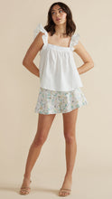 Load image into Gallery viewer, Model wearing white Leigh Top white and light colorful floral shorts from MINKPINK with brown high heel sandals (7352098717904)
