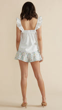 Load image into Gallery viewer, Model wearing white Leigh Top white and light colorful floral shorts from MINKPINK with brown high heel sandals (7352098717904)
