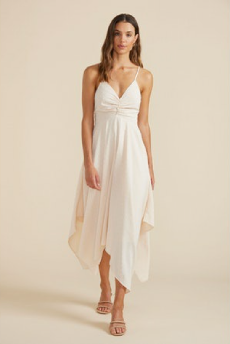 Woman is wearing MINKPINK camilla maxi dress. The dress features V neckline, Thin adjustable straps, Ruched detailing, abstract hemline, Tie up back, Zip closure on low back. The dress is in a stunning ivory color.  (7736893538512)
