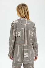 Load image into Gallery viewer, This photo contains a Kimaya shirt from Soaked in Luxury which has horizontal and vertical stripes forming squares with double half circles in the middle in black and beige colors, same view from back (7700578599120)
