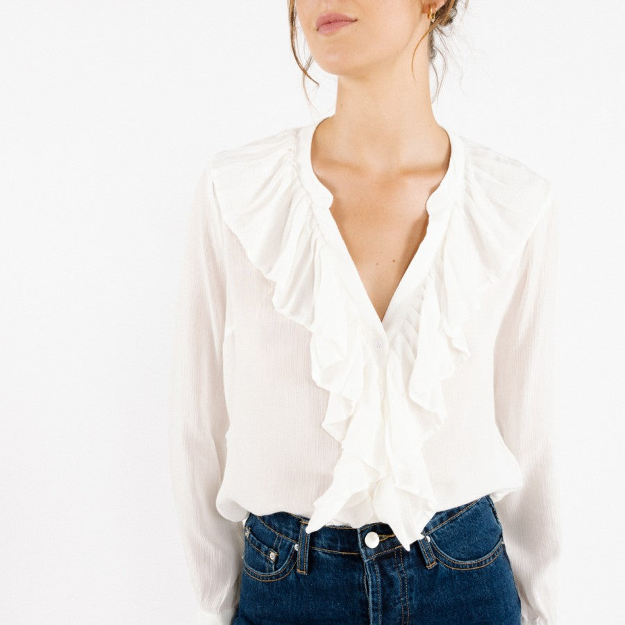 Model is wearing a white ARTLOVE SOLENE Blouse with ruffles on neck and trim  (7341140017360)