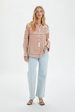 Load image into Gallery viewer, This photo contains a Kimaya shirt from Soaked in Luxury which has horizontal and vertical stripes forming squares with double half circles in the middle in black, brown and beige colors paired with straight leg jeans and sandals. (7700578599120)
