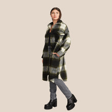 Load image into Gallery viewer, The Model wearing Steve Madden Chloe Shacket. This plaid Long shacket is perfect for cold fall days. The grey, black and dreen pattern makes it easy to wear day to day. (7809890189520)
